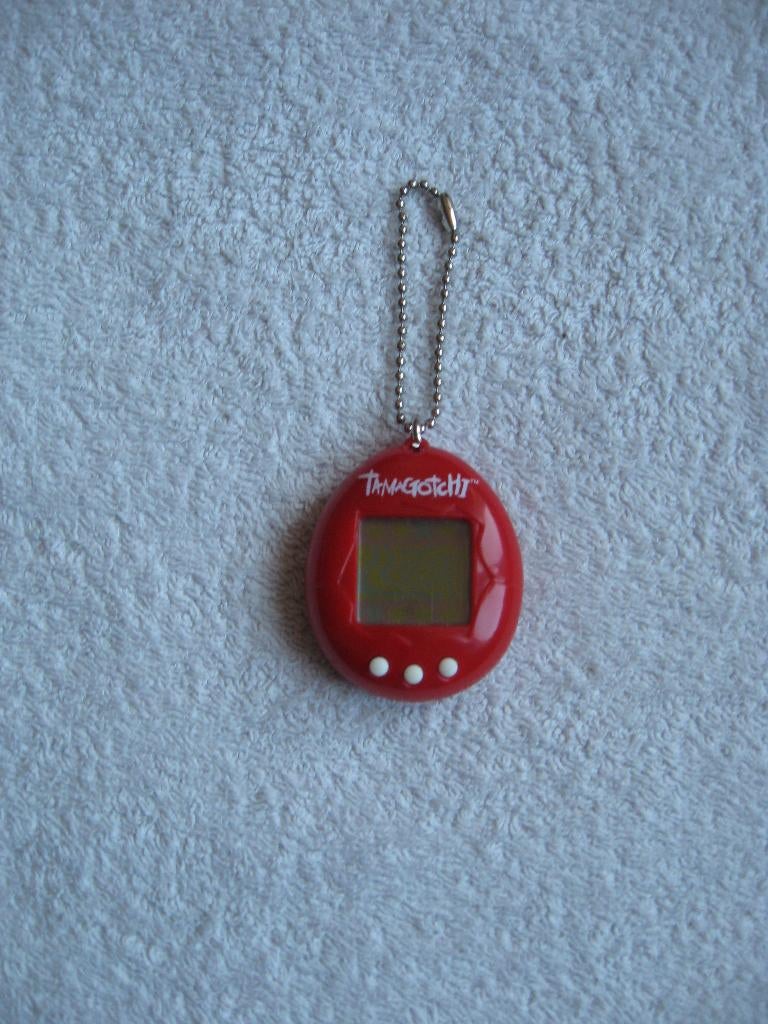 Bandai 1997 - rode Tamagotchi (zie omschrijving), Ophalen of Verzenden, Zo goed als nieuw