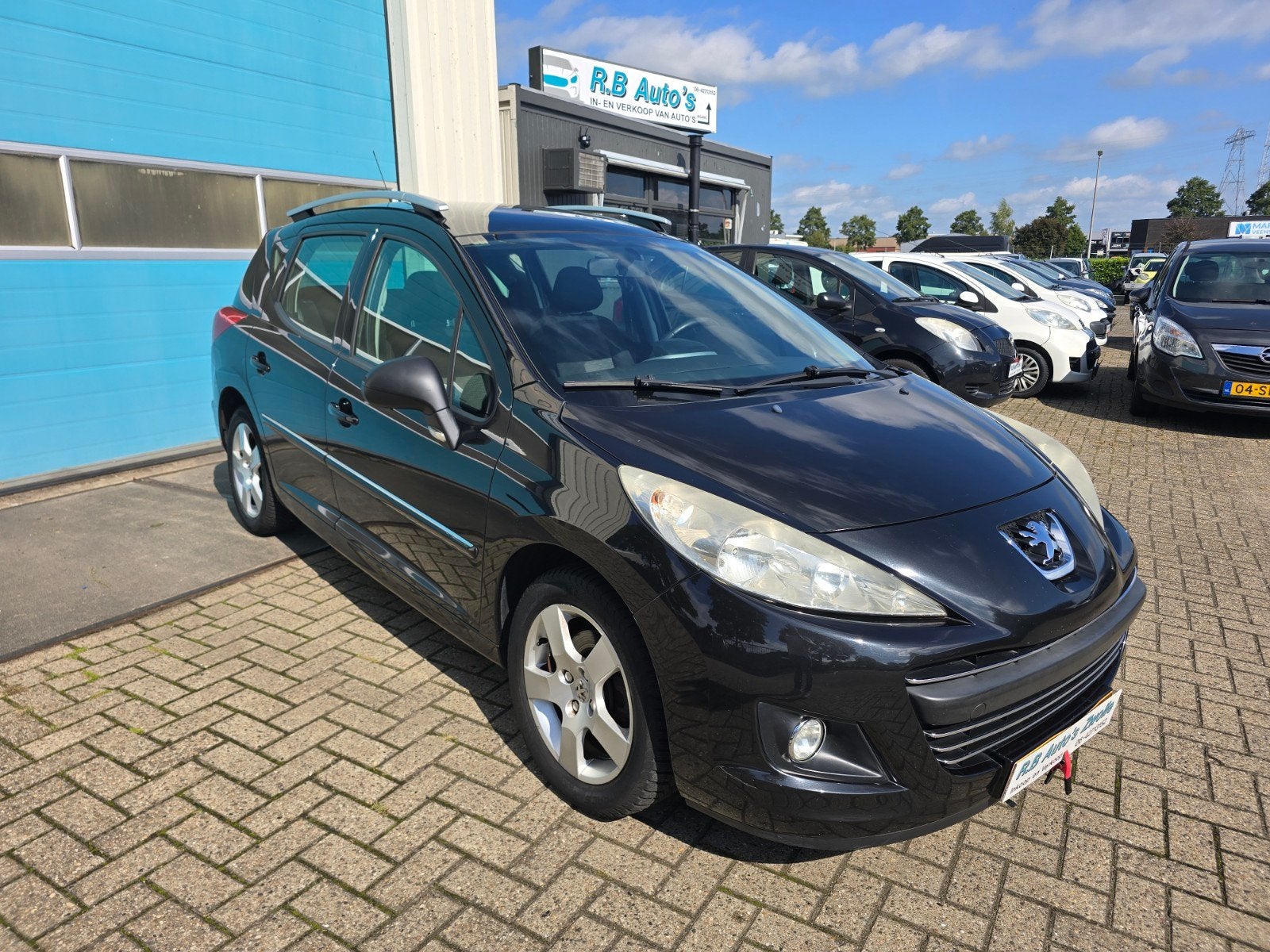 Peugeot 207 1.6 16V SW Outdoor 2009 Zwart, Auto's, Voorwielaandrijving, Stof, Zwart, 4 cilinders