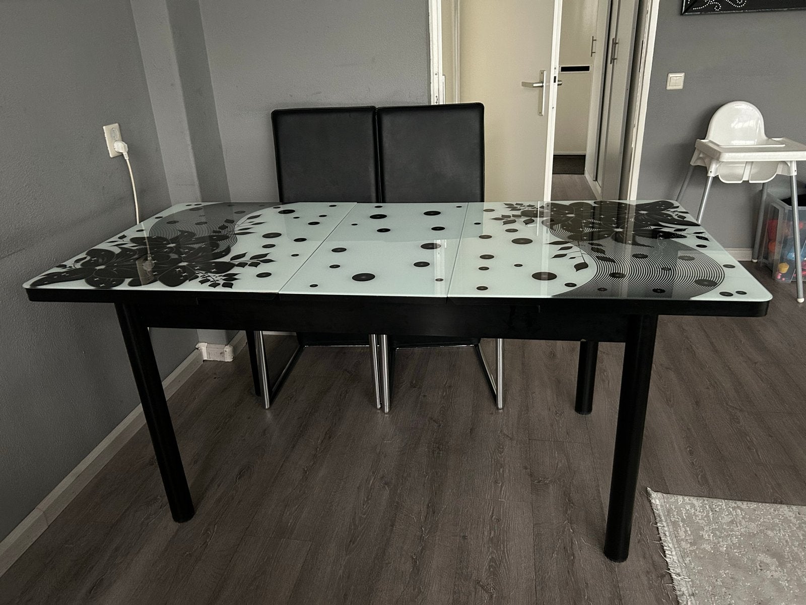 Uitschuifbare eettafel met glazen blad en bloemmotief, Huis en Inrichting, Ophalen, 50 tot 100 cm, Vijf personen of meer, 150 tot 200 cm