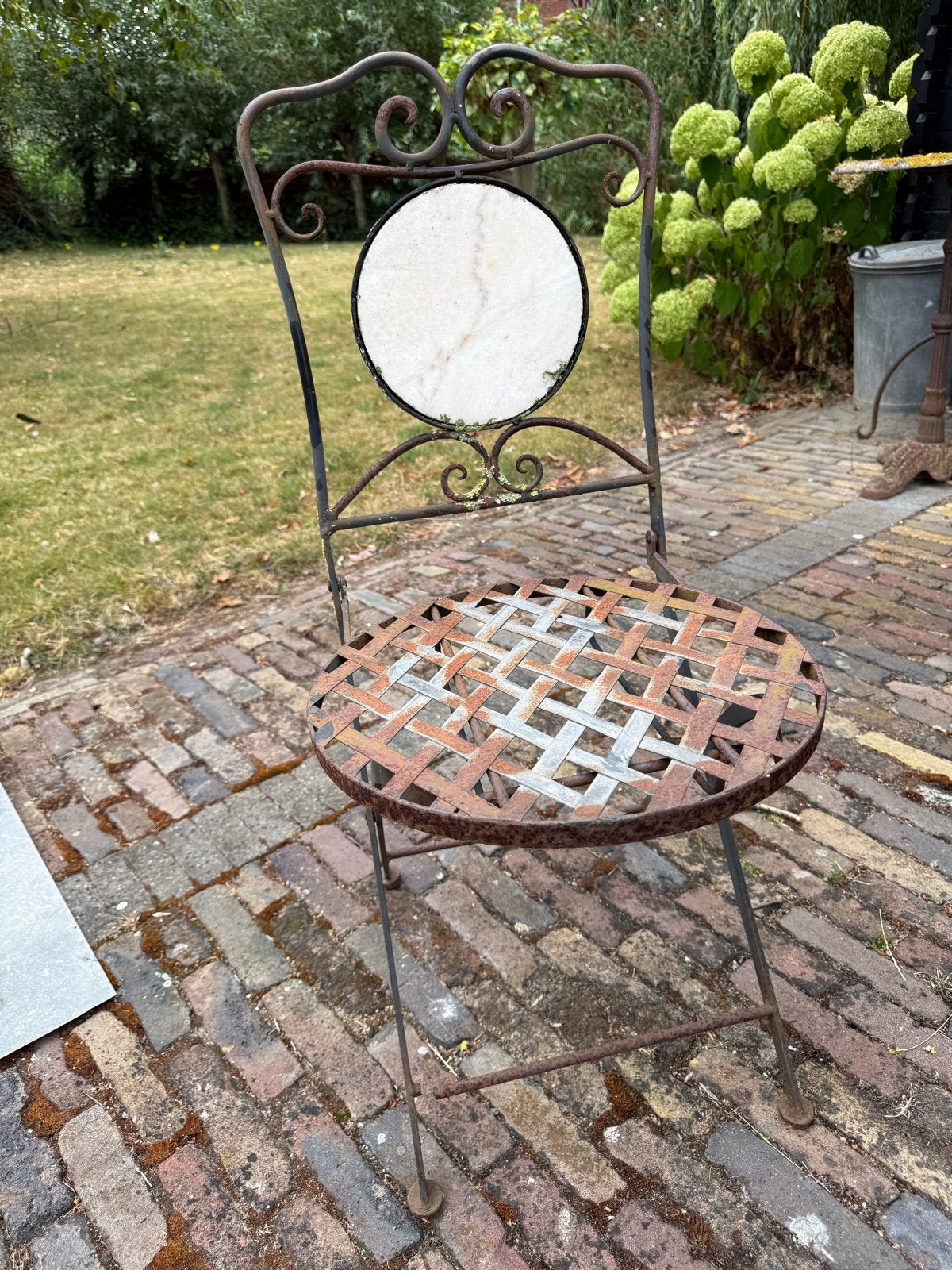 Antieke smeedijzeren tuinstoel met marmeren rugleuning, Ophalen