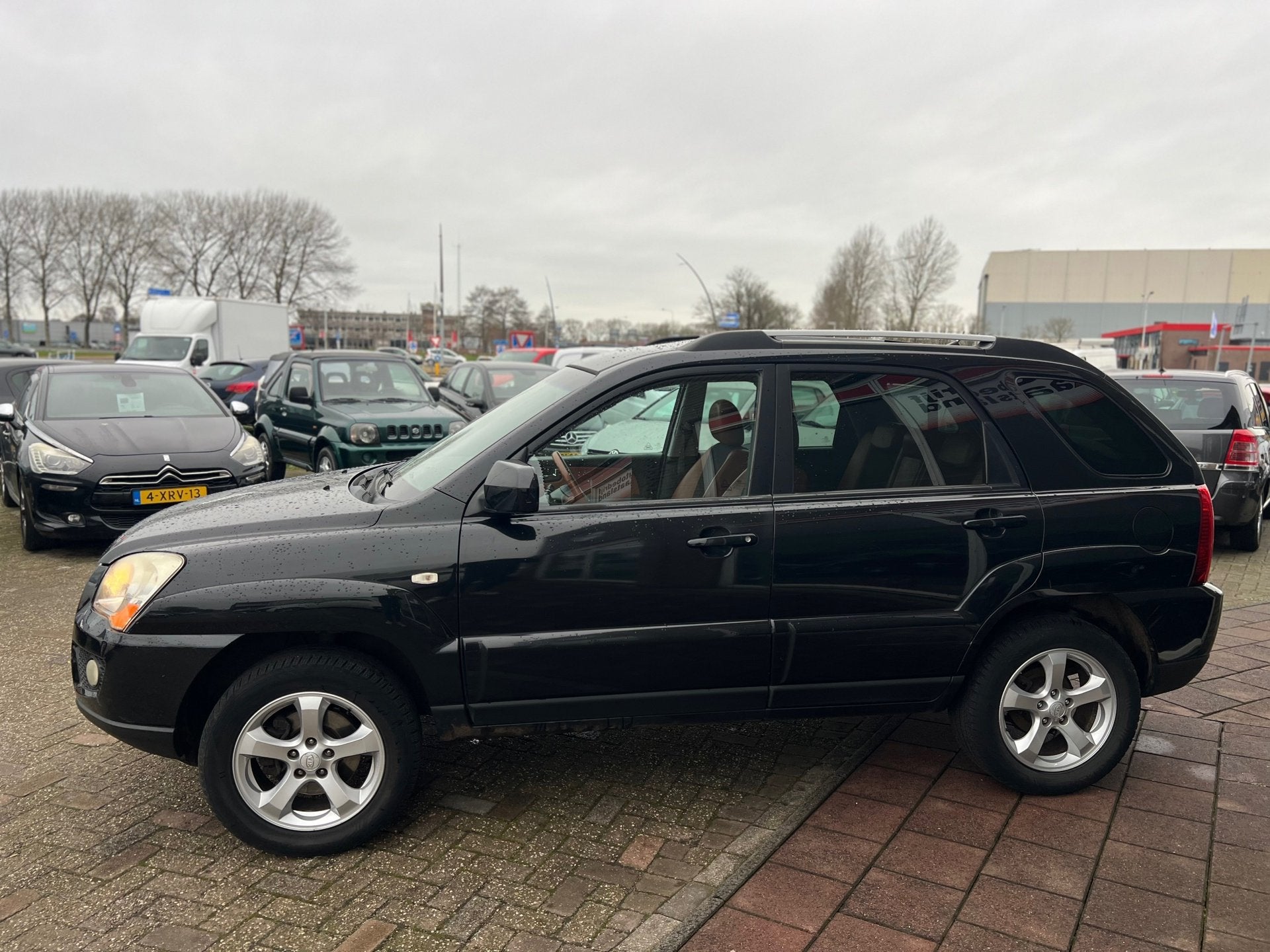 Kia Sportage 2.0 CVVT Fifteen - Leer - Clima - Cruise -, Auto's, 1442 kg, Gebruikt, Zwart, 4 cilinders