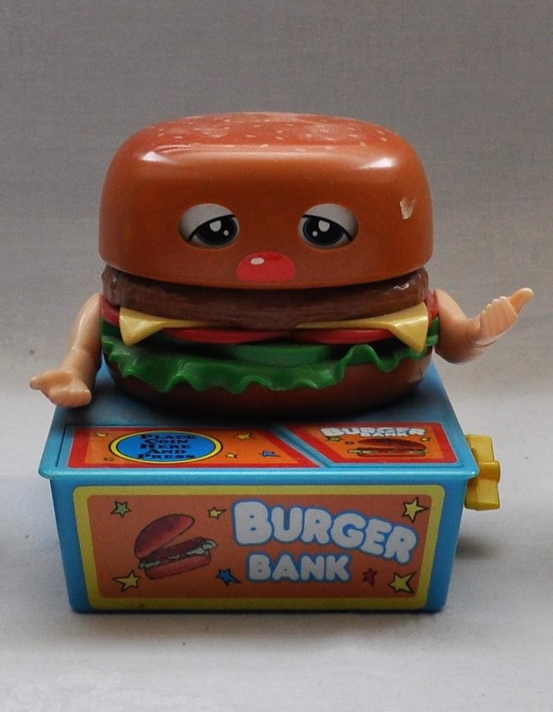 Vintage Opwind Spaarpot Hamburger 11,5 cm HAPERT, Ophalen of Verzenden, Gebruikt, Kunststof, Overige thema's