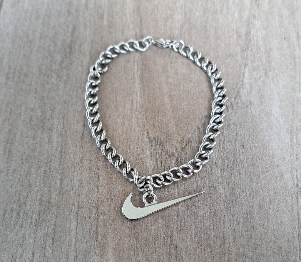 Nike armband, Staal, Nieuw, Ophalen of Verzenden, Met bedels of kralen