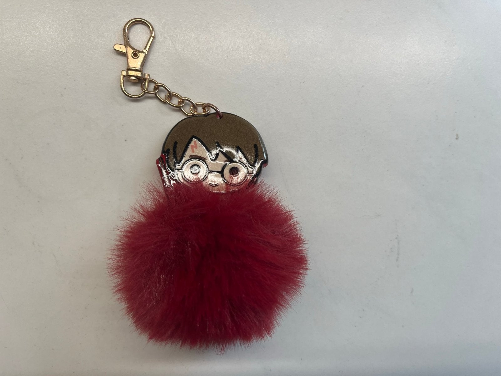 Harry Potter sleutelhanger met rode pompon, Verzamelen, Harry Potter, Ophalen of Verzenden, Zo goed als nieuw, Gebruiksvoorwerp