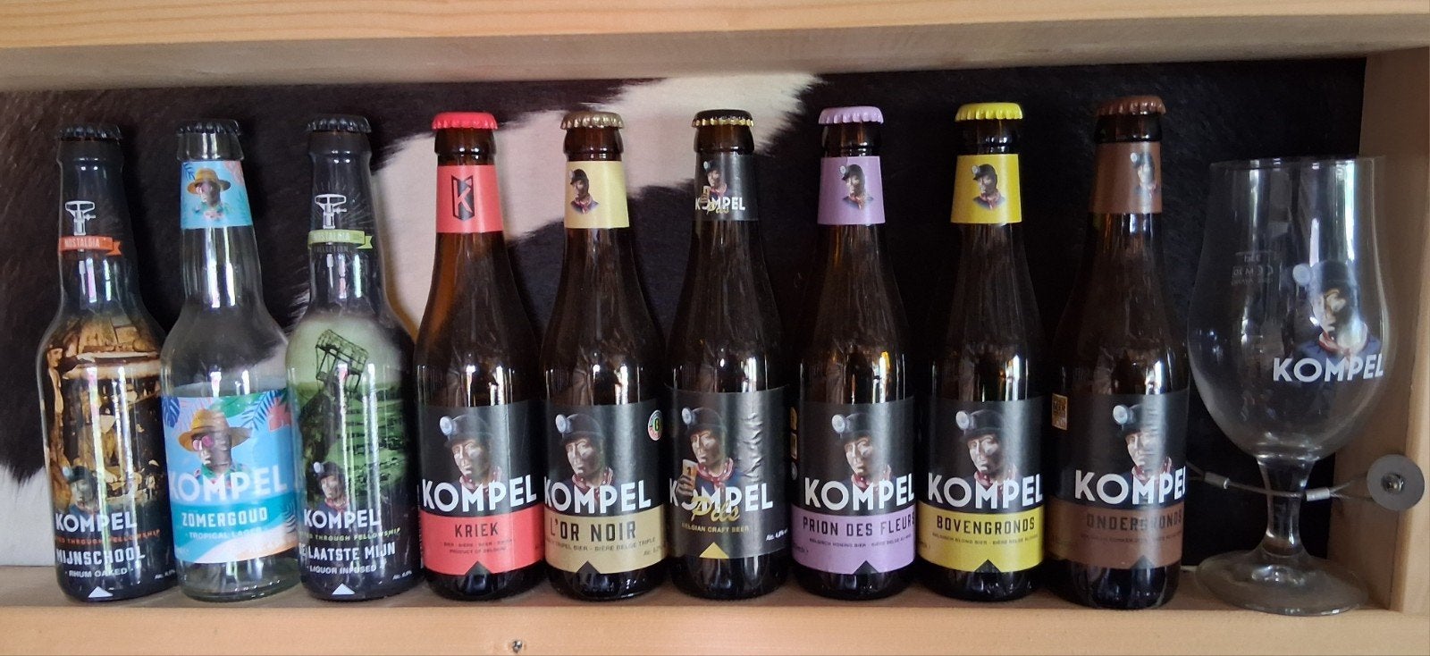 9 lege Kompel bierflesjes + Kompel drinkglas, Ophalen of Verzenden, Gebruikt, Flesje(s), Overige merken