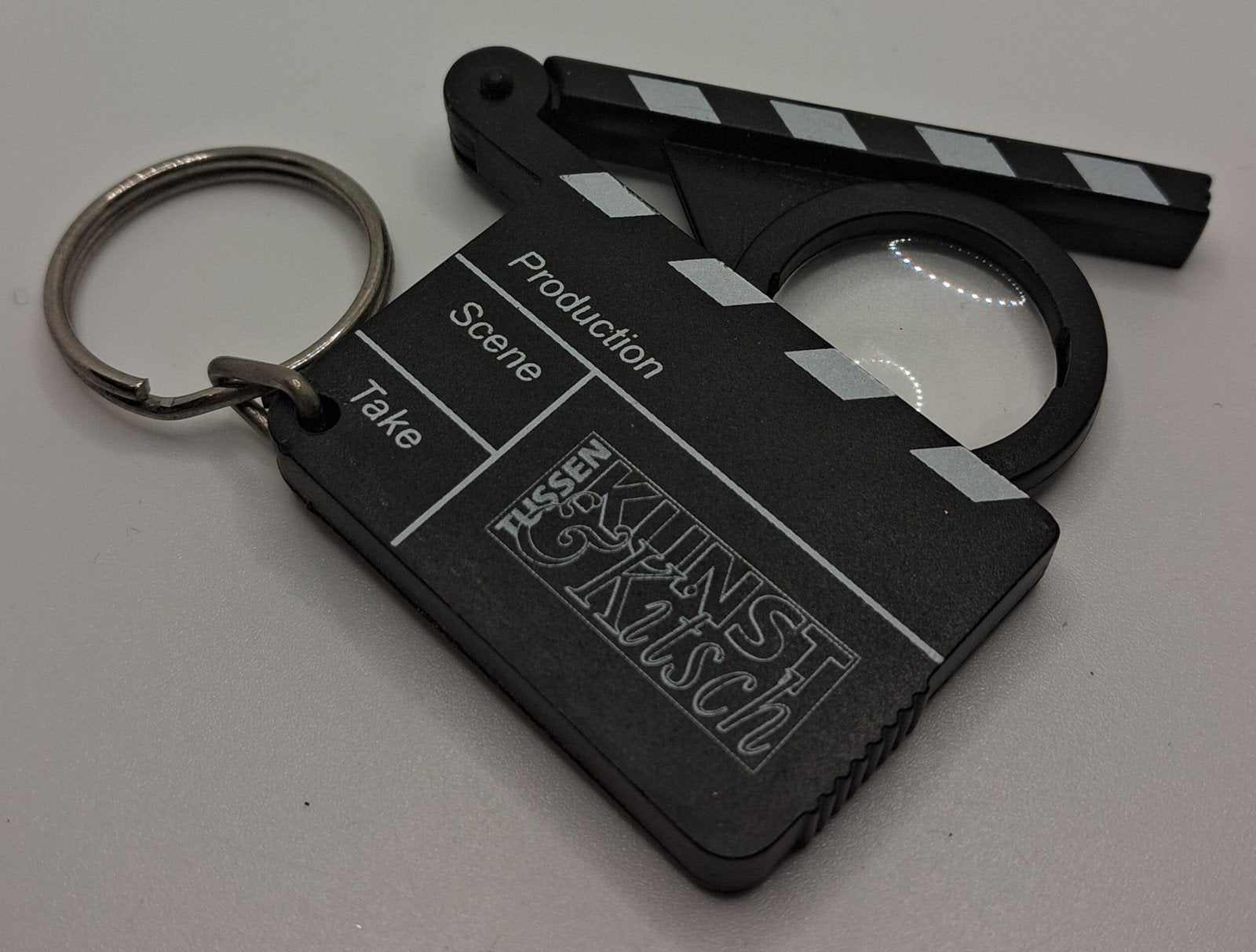 Filmklapper sleutelhanger met vergrootglas, Ophalen of Verzenden, Nieuw, Overige typen