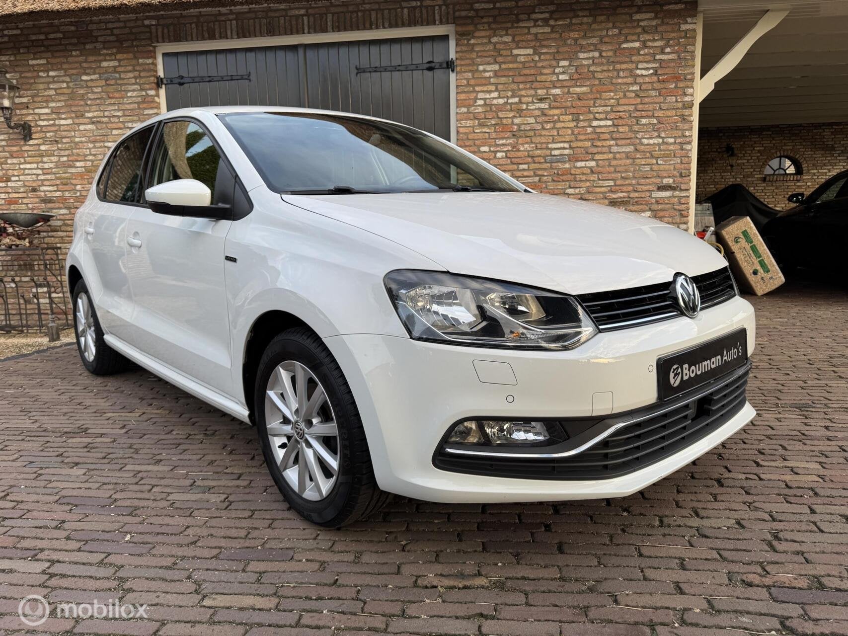 Volkswagen Polo 1.2 TSI Lounge - 5 Deurs - nieuwe apk, Auto's, Verwarmde buitenspiegels, Gebruikt, 4 cilinders, Wit