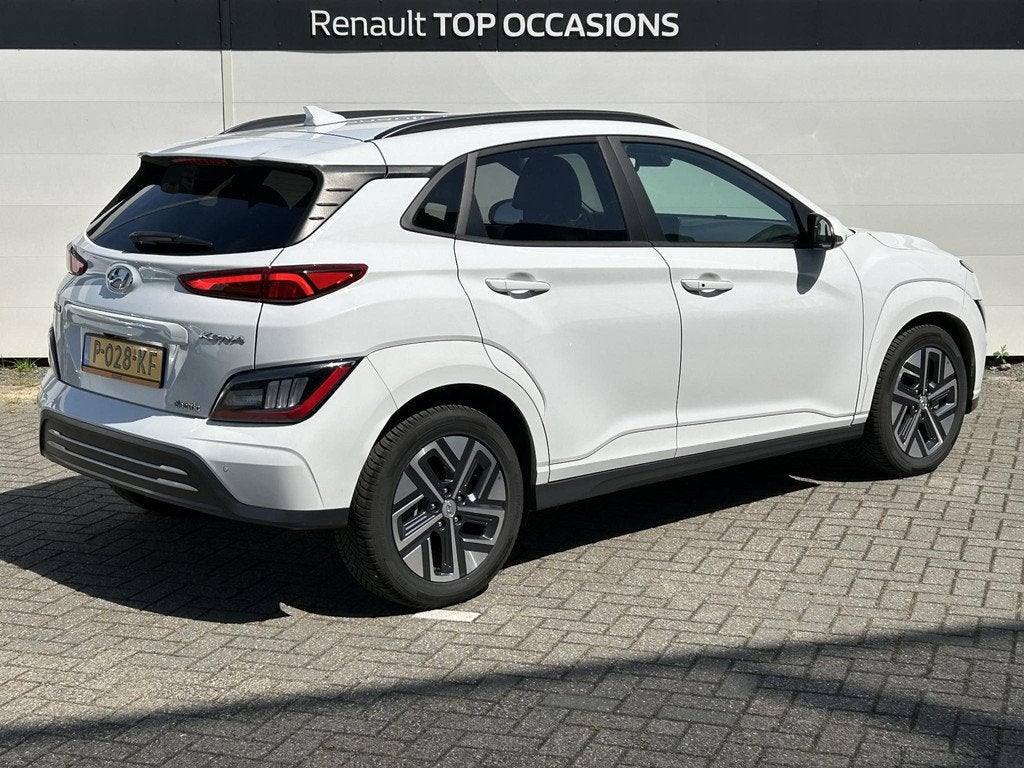 Hyundai Kona EV Premium 64 kWh | SoH 100% | Full Options | A, Auto's, Hyundai, Gebruikt, Huisgarantie, Met garantie (alle), Wit