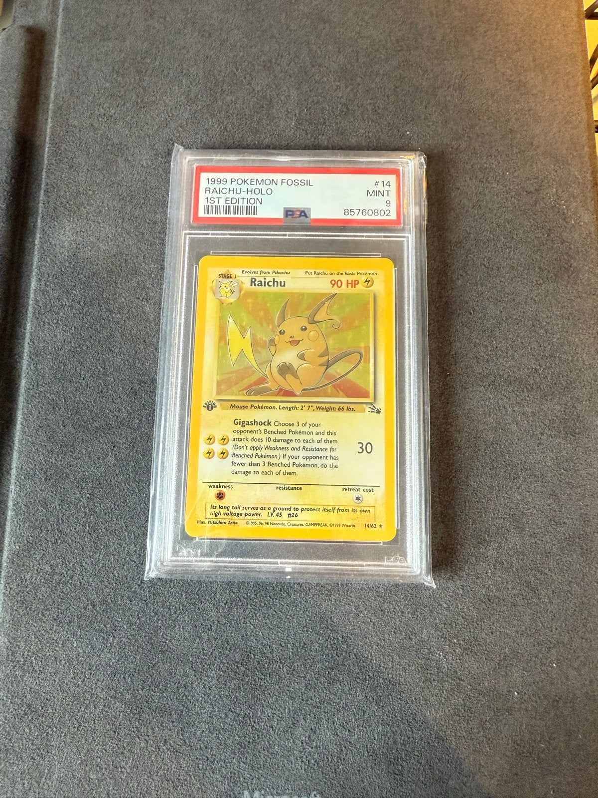 PSA 9 1999 Pokemon Fossil Raichu #14 Holo 1st Edition, Ophalen of Verzenden, Zo goed als nieuw, Losse kaart