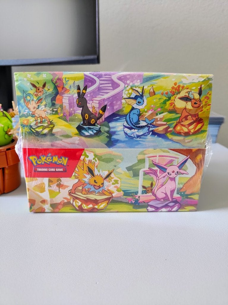 Prismatic Evolutions Tin Display Sealed 8 stuks New ETB Box, Ophalen of Verzenden, Nieuw, Boosterbox, Foil
