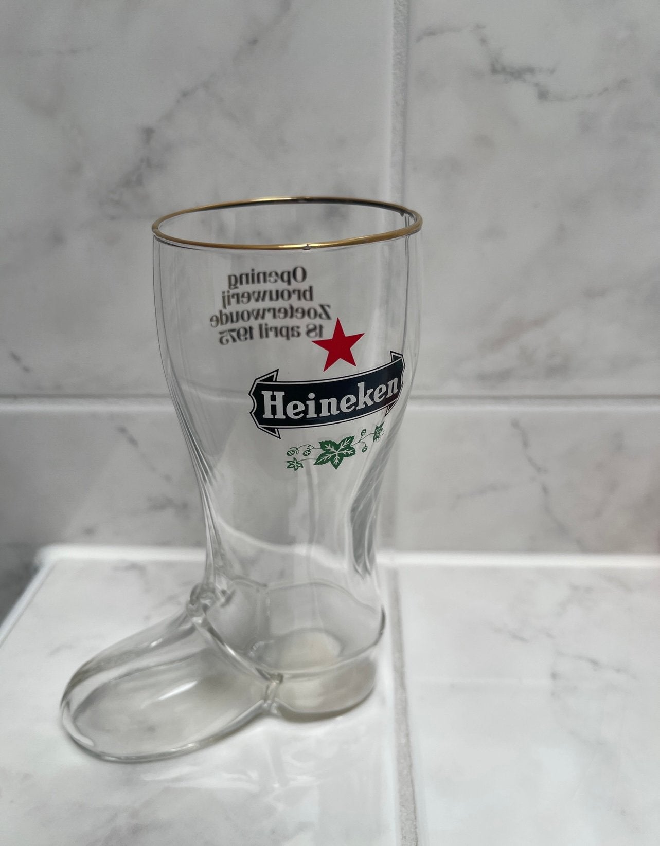 HEINEKEN GLAS - laars uit 1975 - opening Zoeterwoude, Ophalen of Verzenden, Zo goed als nieuw, Glas of Glazen, Heineken