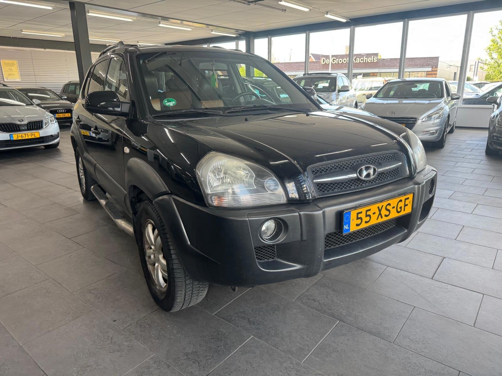 Hyundai Tucson 2.0i Style Premium LPG g3 leer clima cruise c, Auto's, Dealer onderhouden, 4 cilinders, Zwart, Handgeschakeld