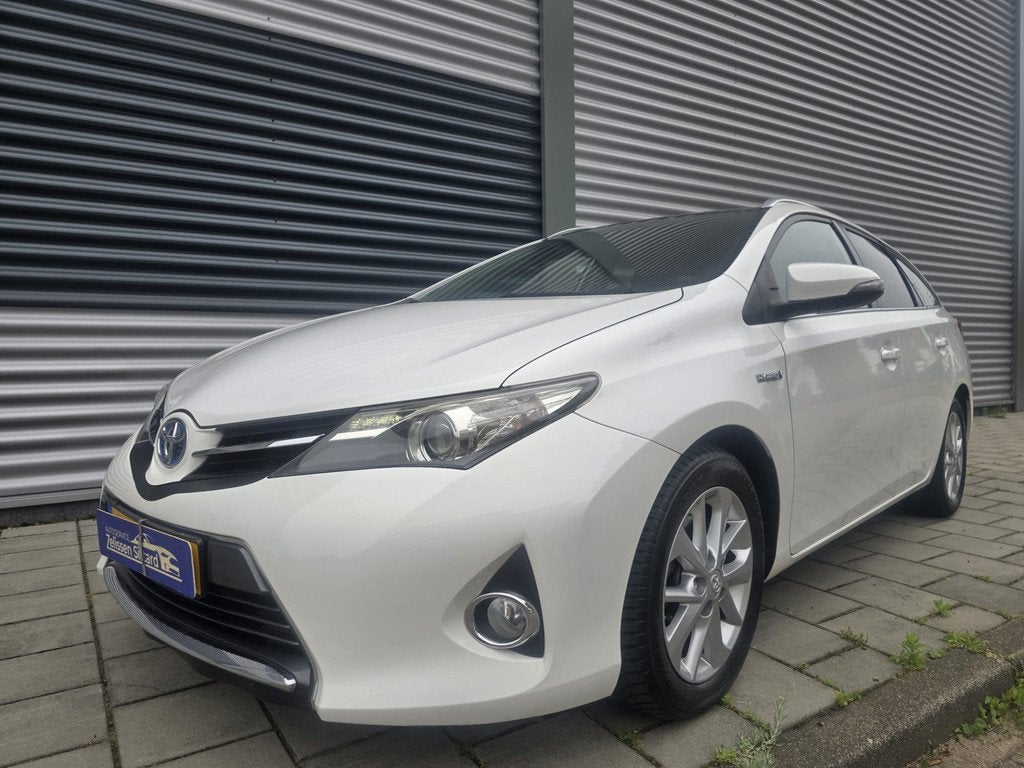 Toyota Auris Touring Sports 1.8 Hybrid Lease (bj 2014), Auto's, Euro 5, Gebruikt, Wit, Hybride Elektrisch/Benzine