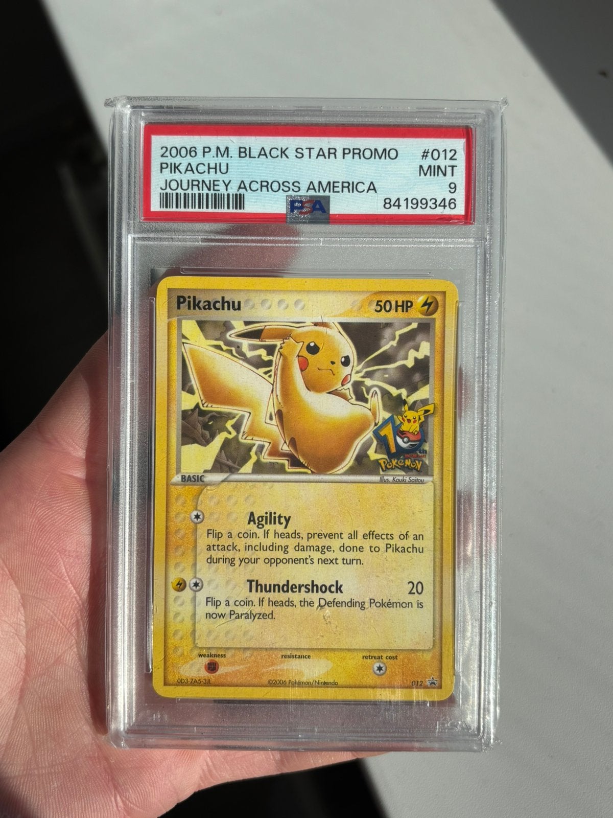 PSA 9 Mint Pikachu 012 Journey Across America, Ophalen of Verzenden, Zo goed als nieuw