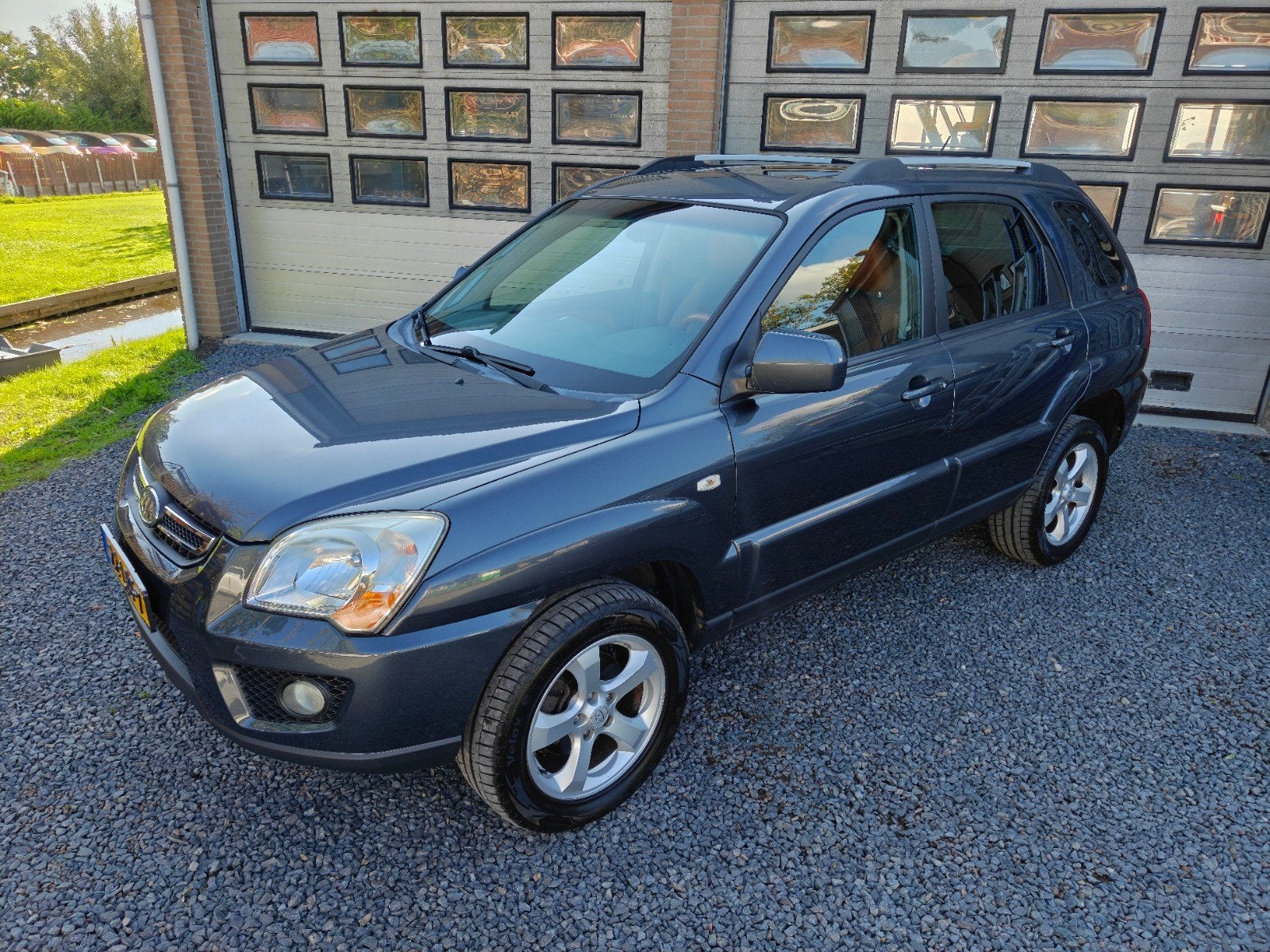 Kia Sportage 2.0 4WD 2010 Grijs, Auto's, 4 cilinders, Leder en Stof, Origineel Nederlands, Bruin