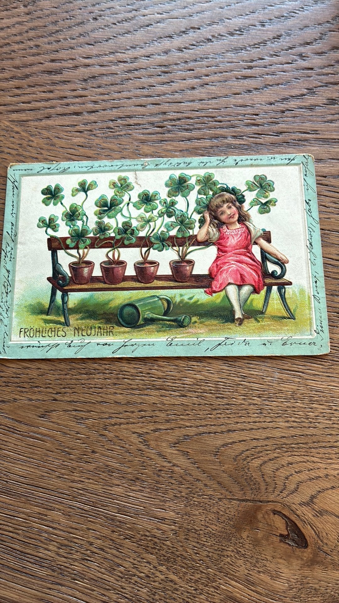 Reliefkaart.Nieuwjaar.1911.Meisje op bank met potten klaver., Ophalen of Verzenden, Voor 1920, Gelopen, Feest(dag)