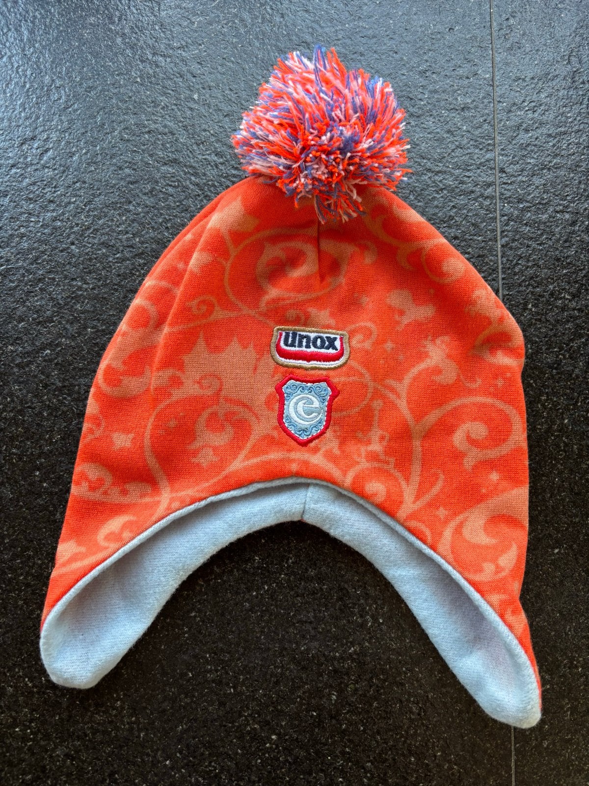 Unox Muts met pompon - Oranje/Blauw, Kleding | Heren, Mutsen, Sjaals en Handschoenen, Ophalen of Verzenden, Muts