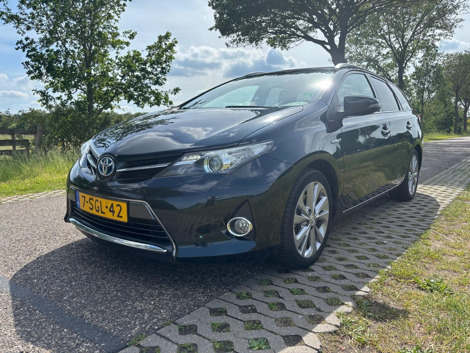 Toyota Auris 1.8 Hybrid Panodak Touring Sports CVT, Auto's, Toyota, Stof, Zwart, Origineel Nederlands, 25 km/l