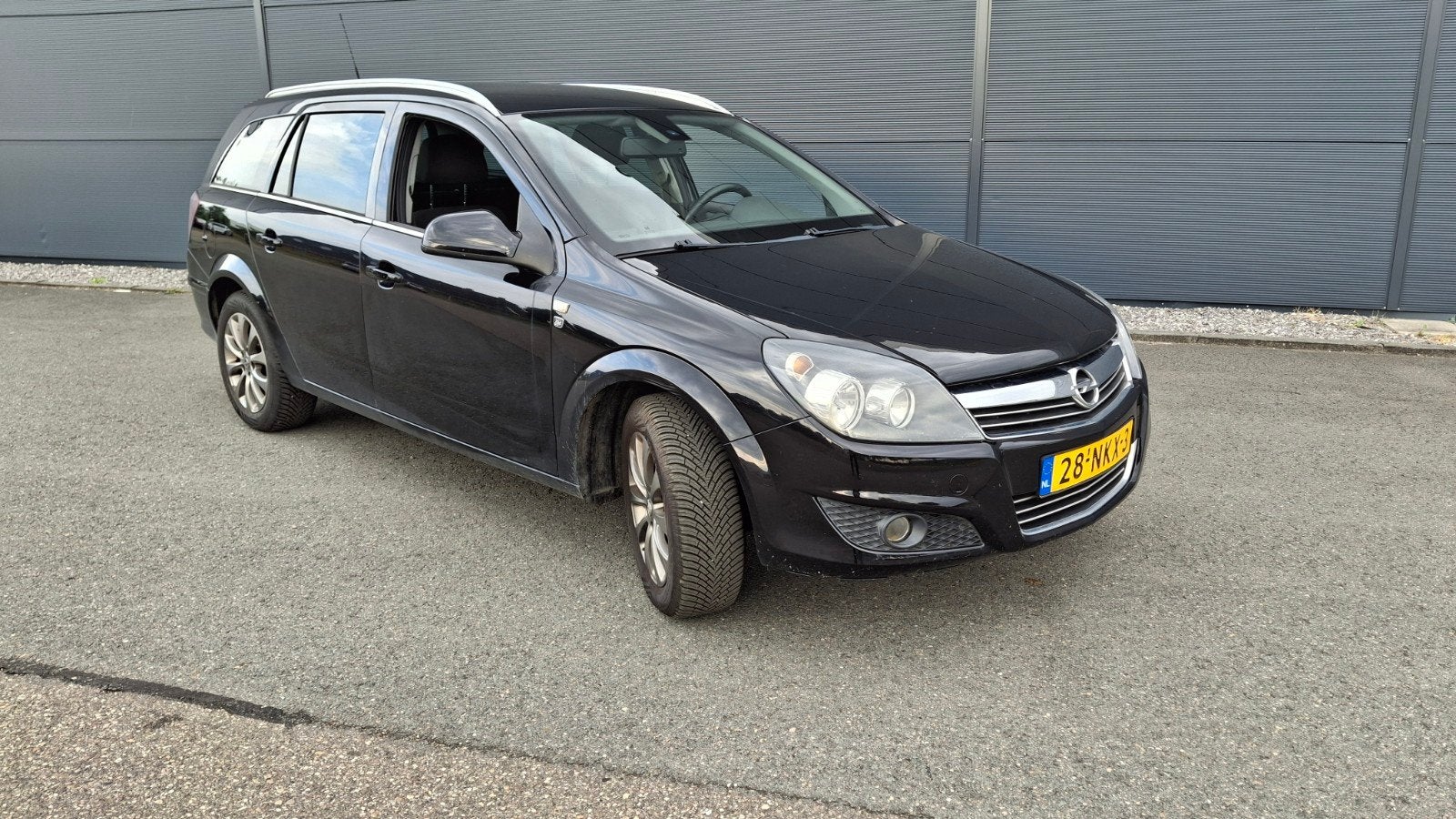 Opel Astra 1.6 16V 85KW St.wgn. 2010 Zwart, Auto's, Voorwielaandrijving, Stof, Zwart, Origineel Nederlands