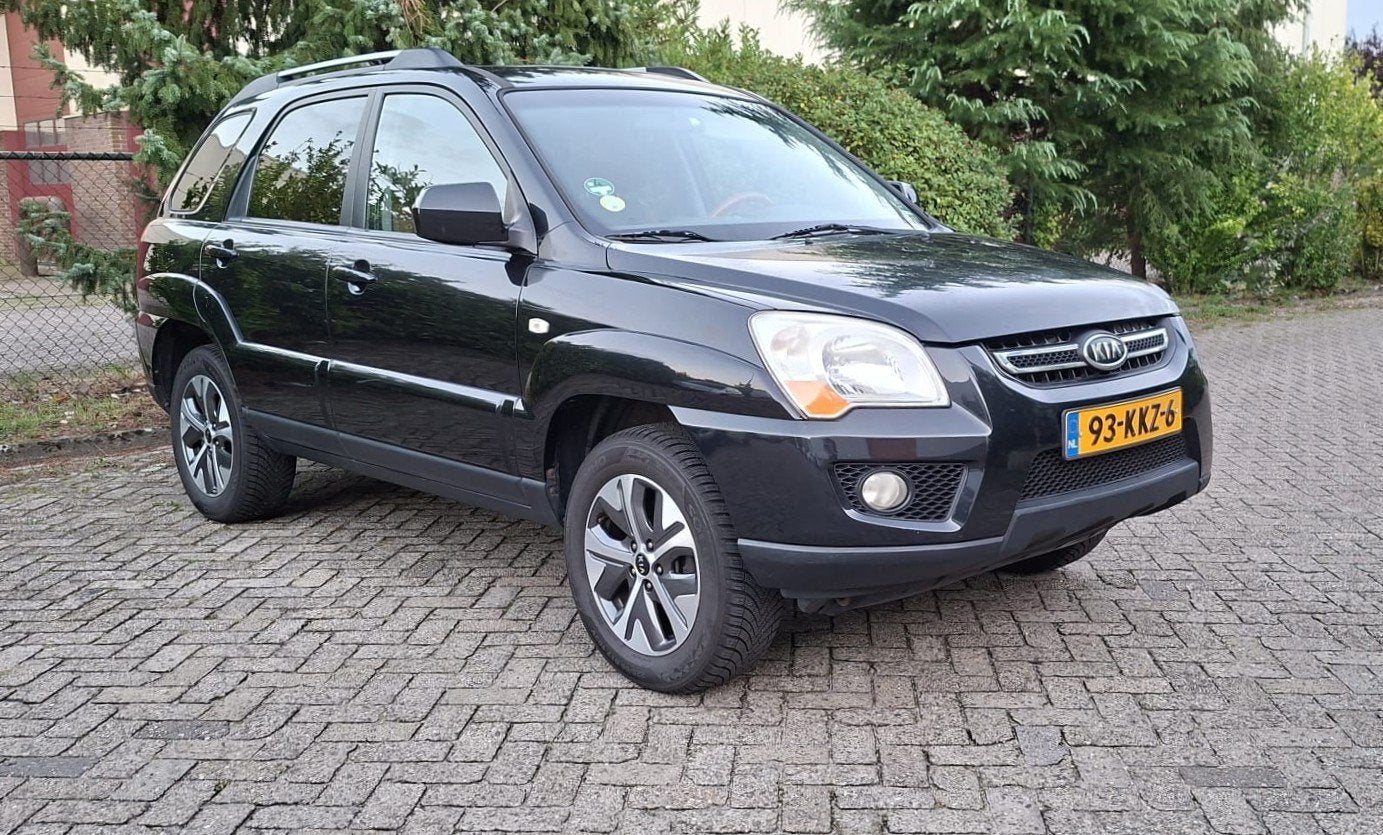 Kia Sportage 2.0 CVVT Fifteen lees advertentie, Auto's, 1442 kg, 4 cilinders, Leder en Stof, Zwart