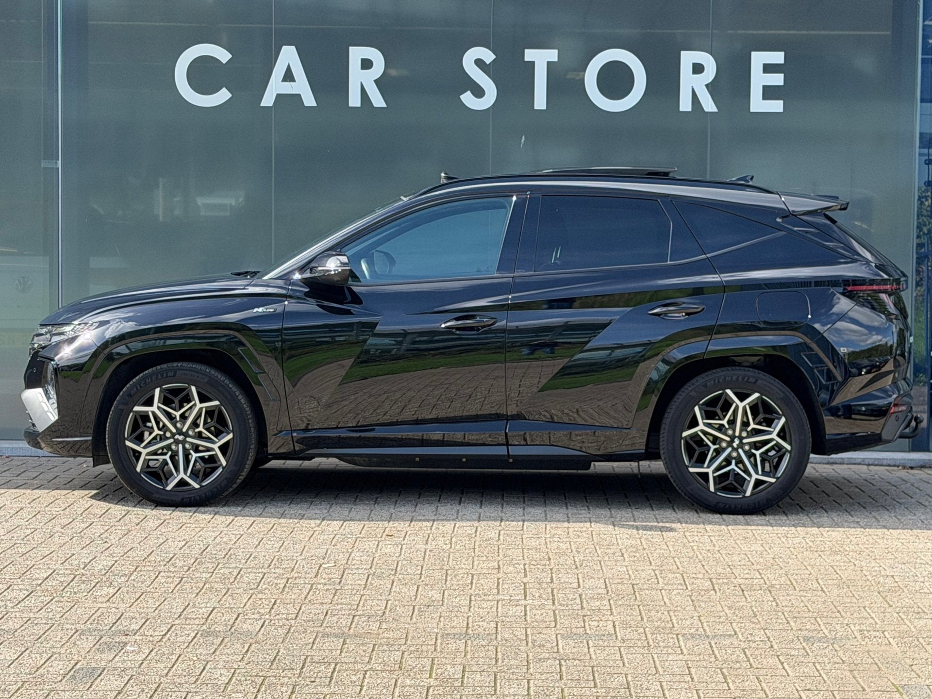 Hyundai Tucson 1.6 T-GDI PHEV N Line Sky 4WD PANO/TREKHAAK/N, Auto's, Automaat, Gebruikt, 4 cilinders, Zwart