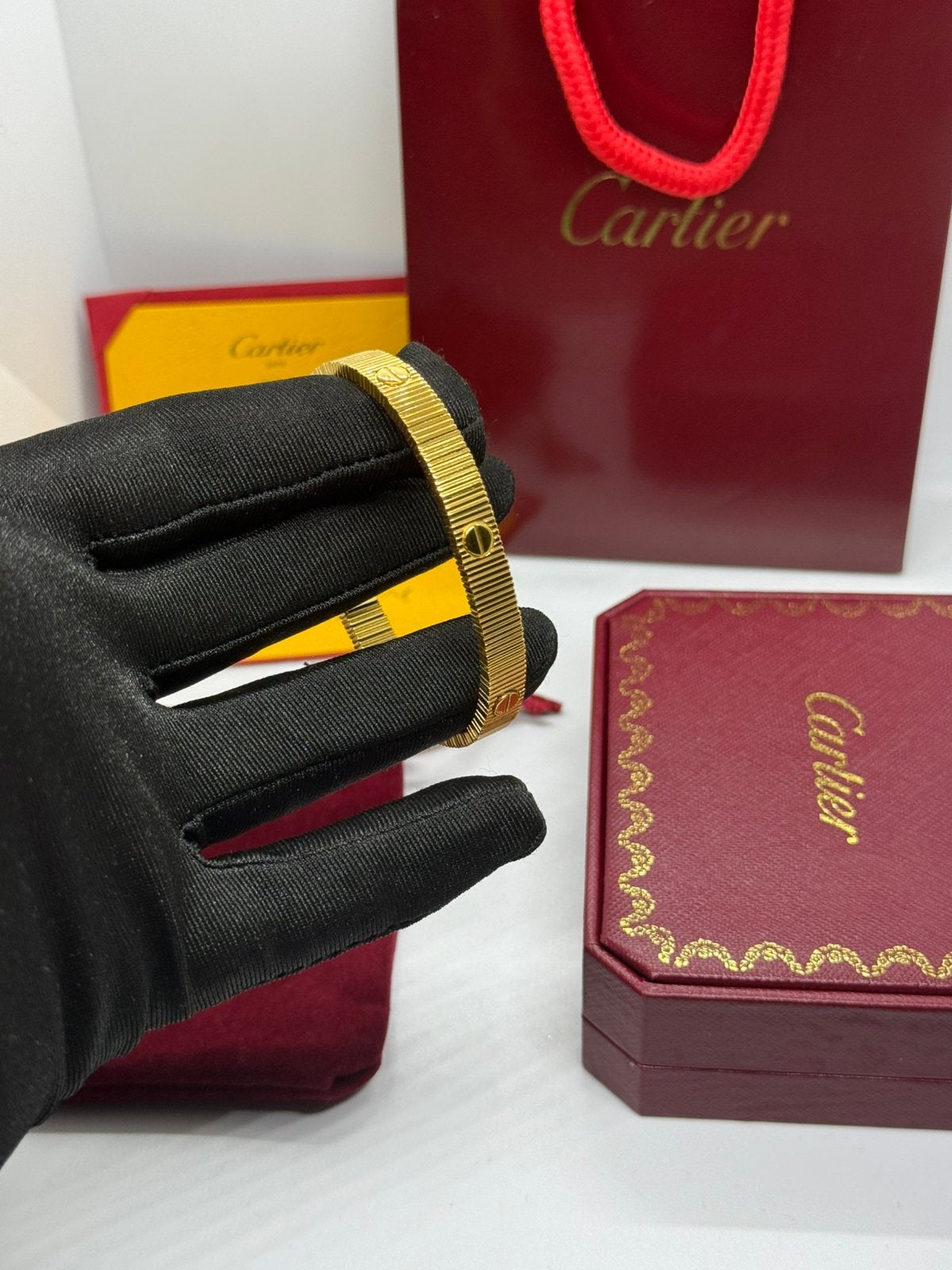 Cartier LOVE UNLIMITED-ARMBAND, FLEXIBEL, Sieraden, Tassen en Uiterlijk, Armbanden, Ophalen of Verzenden, Zo goed als nieuw, Goud