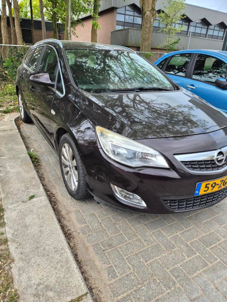 Opel Astra 1.4 Turbo 88KW Sports Tourer 2012 Bruin, Auto's, Voorwielaandrijving, Zwart, 4 cilinders, Bruin