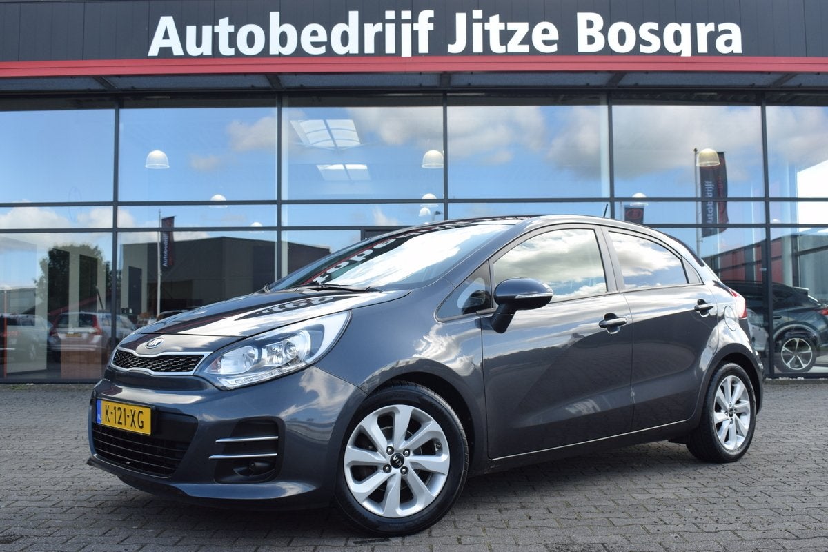 Kia Rio 1.2 CVVT ExecutiveLine ECC | Full Map Navi | Camera, Auto's, 1027 kg, 4 cilinders, Met garantie (alle), Verwarmde buitenspiegels