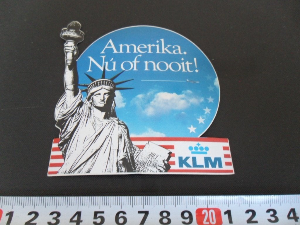 sticker Amerika. Nú of nooit !   KLM   Luchtvaart, Ophalen, Zo goed als nieuw
