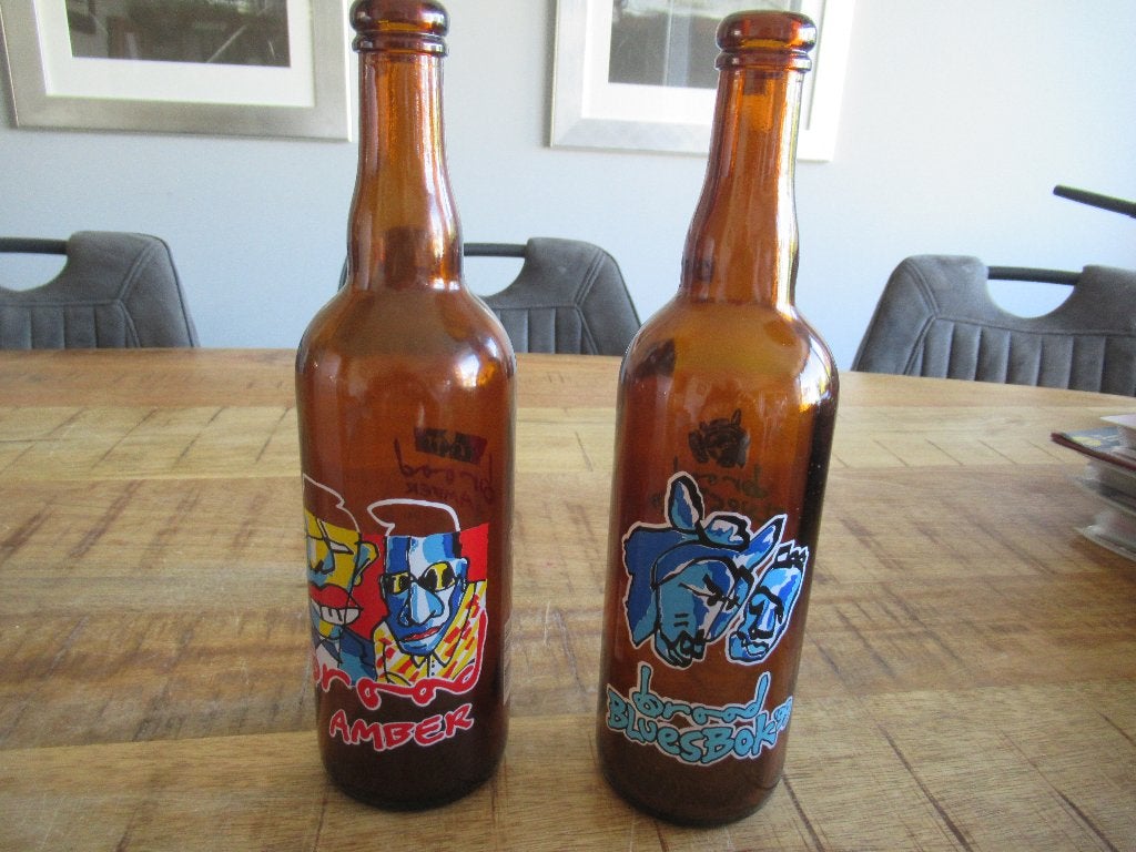 2 Herman Brood bierflessen flessen. Amber + Bluesbok '99, Ophalen of Verzenden, Zo goed als nieuw, Flesje(s), Overige merken