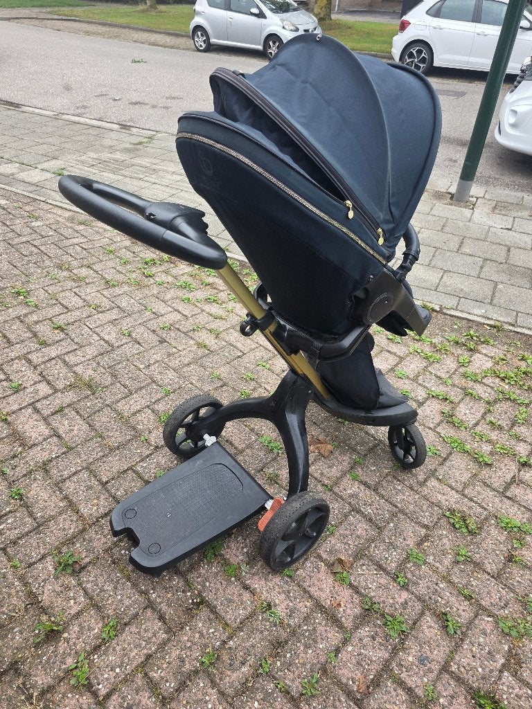 Stokke Kinderwagen Zwart/Goud Compleet met Reiswieg & Buggy, Ophalen of Verzenden, Gebruikt, Overige merken, Verstelbare duwstang