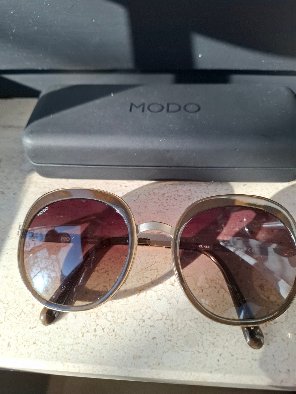 MODO zonnebril titanium glazen, Ophalen of Verzenden, Bruin, Zonnebril