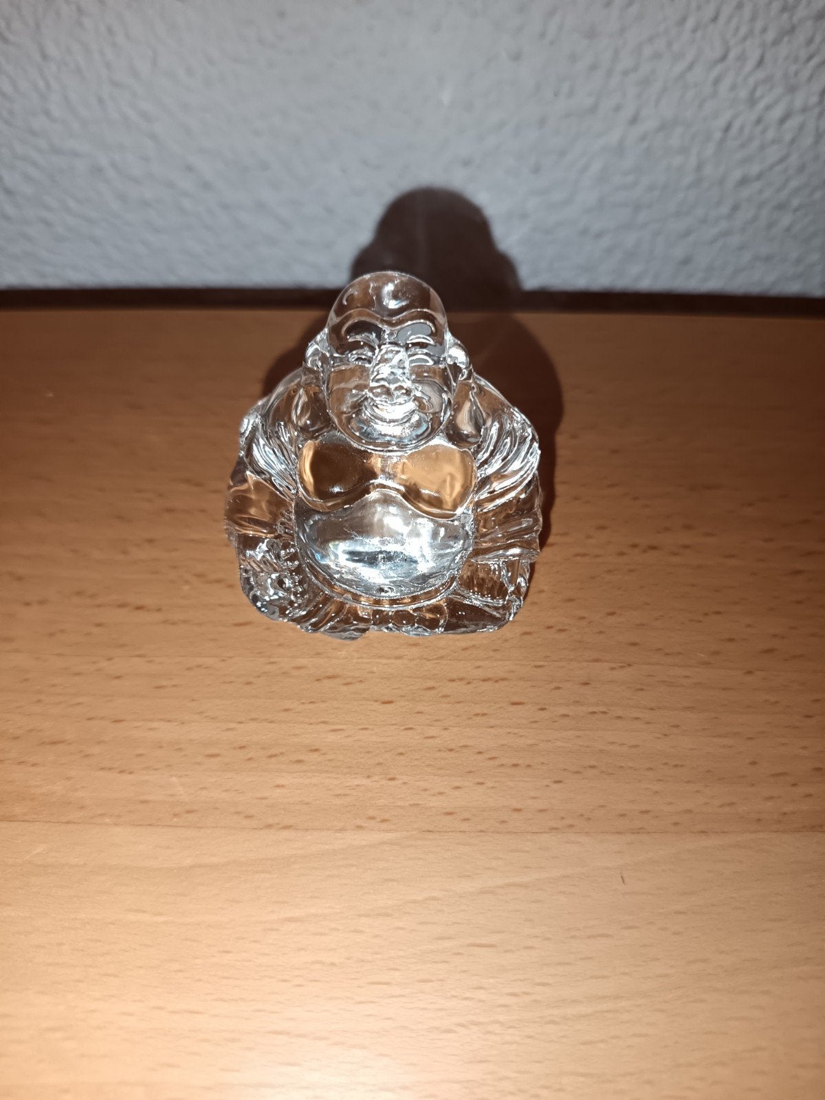Kleine glazen Boeddha, Ophalen