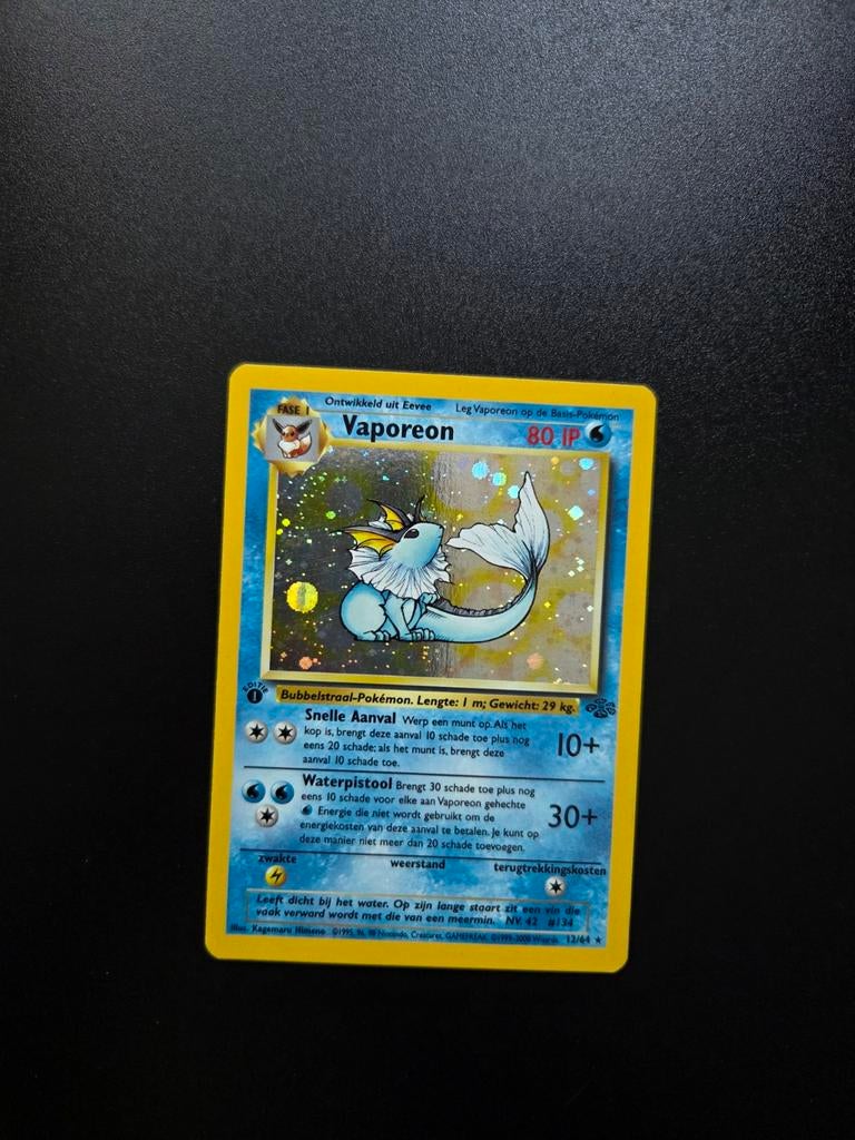 Vaporeon 12/64 Pokemon Jungle NL holo 1st edition, Ophalen of Verzenden, Zo goed als nieuw, Booster, Foil