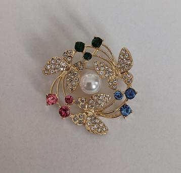 Vlinderkrans broche beschikbaar voor biedingen