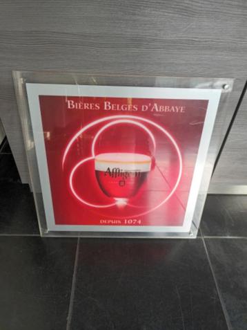 Reclamebord affligem achter plexiglas beschikbaar voor biedingen