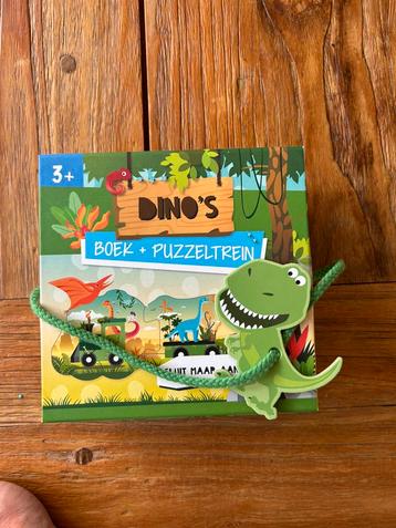 Dino puzzeltrein en boekje zo goed als nieuw beschikbaar voor biedingen