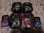 Paldean Fates tins LEEG, Hobby en Vrije tijd, Verzamelkaartspellen | Pokémon, Ophalen of Verzenden, Zo goed als nieuw