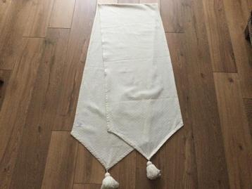 Een mooie crèmekleurige tafelloper met kwasten beschikbaar voor biedingen