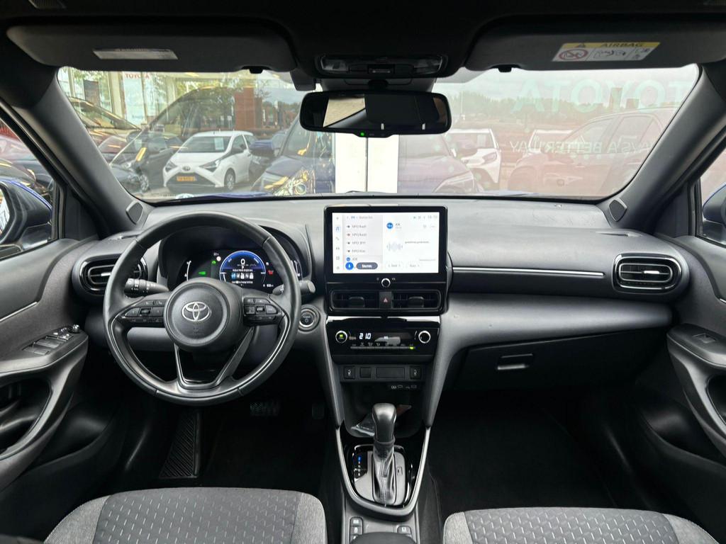 Toyota Yaris Cross 1.5 Hybrid 115 First Edition | Plus Pack, Stof, Gebruikt, Blauw, 116 pk