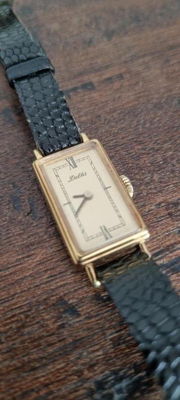 Vintage Delta horloge – goudkleurig met zwarte leren band –  beschikbaar voor biedingen