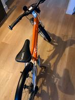 Woom 4 Kinderfiets Oranje - Zo goed als nieuw!, Fietsen en Brommers, Ophalen, Versnellingen, Zo goed als nieuw, Woom