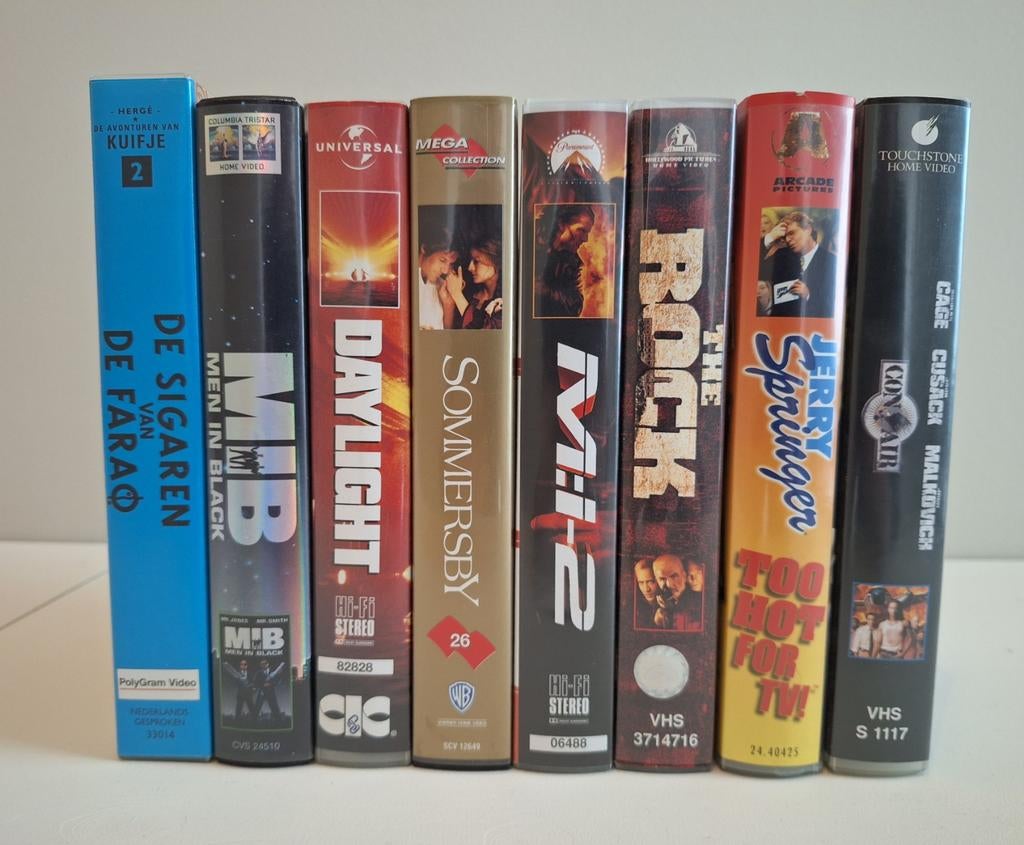 Set van 8 VHS banden: MIB, The Rock, Kuifje, Con Air e.a., Alle leeftijden, Ophalen, Gebruikt