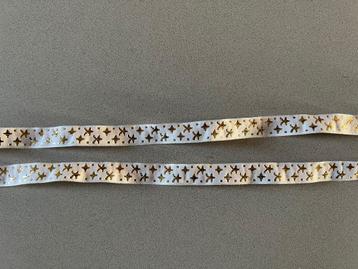 Twee roomkleurige linten band met goudkleurige sterren erop beschikbaar voor biedingen