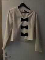 Nikkie beige top met zwarte strikken, maat L, Kleding | Dames, Tops, Ophalen of Verzenden, Nieuw, Beige, Lange mouw