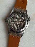 Handopwind world time horloge Merkur met clear caseback, Ophalen of Verzenden