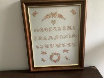 Oude merklap ingelijst beschikbaar voor biedingen