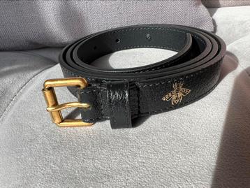 Gucci black leather belt adorned with golden bees and stars