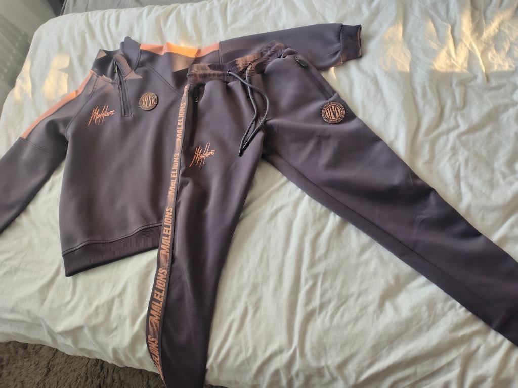 Heel mooi malelions trainingspak in zeer nette staat 140 152, Ophalen of Verzenden, Zo goed als nieuw