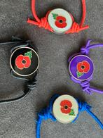 Poppy Armband - logo metaal en elastieken bandje, Ophalen of Verzenden, Overige soorten, Engeland, Overige typen
